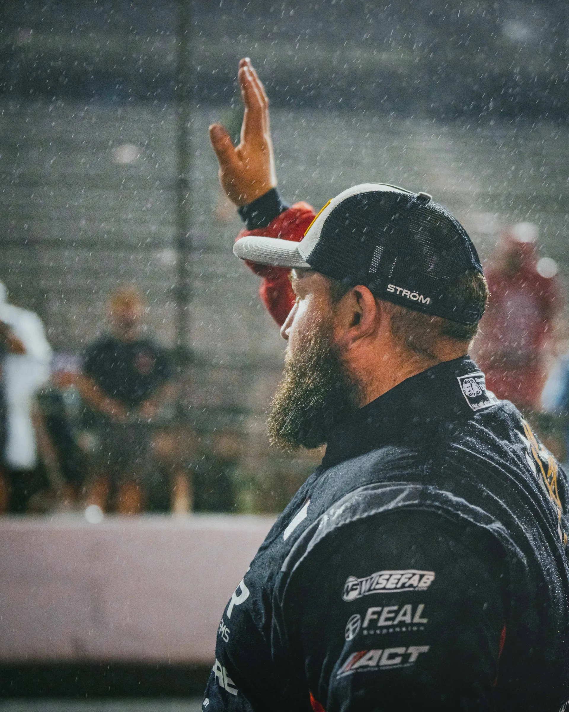 Driver acknowledging the crowd in the rain